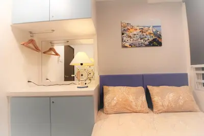 a bedroom with a bed with a desk and a mirror at H2H - Marine Home @ Majestic Ipoh (8~10 Guests) in Ipoh
