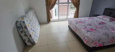 a bedroom with a bed and a window at My 4Rooms Apartment @ Golden Hills Pasar Malam in Cameron Highlands