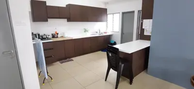 a kitchen with brown cabinets and a black chair at My 4Rooms Apartment @ Golden Hills Pasar Malam in Cameron Highlands