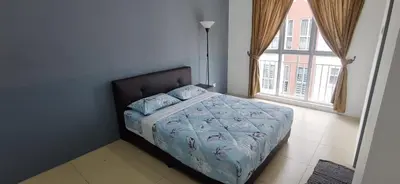 a bedroom with a bed with a blue comforter and a window at My 4Rooms Apartment @ Golden Hills Pasar Malam in Cameron Highlands