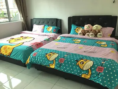 two beds with hello kitty comforters and stuffed animals at W9 atGoldenHills NightMarket WiFi 4R BBQ in Cameron Highlands