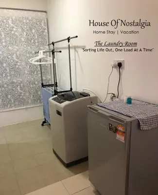 a room with two refrigerators sitting next to a wall at House Of Nostalgia in Lumut