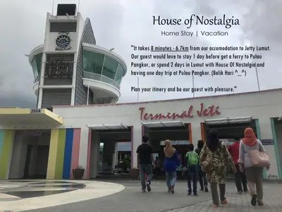 a group of people walking in front of a building at House Of Nostalgia in Lumut