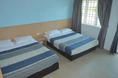 two beds in a hotel room with two bedsskirtspectspectssenalsenalsenalsenal at My Home N2 @ Golden Hills Night Market in Cameron Highlands
