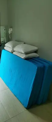 a blue bed with two pillows on top of it at My Home N2 @ Golden Hills Night Market in Cameron Highlands