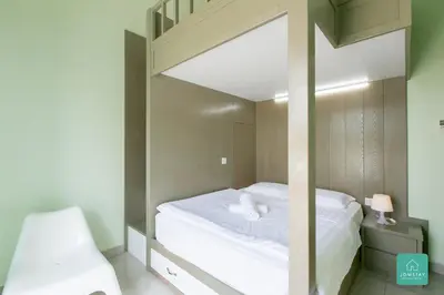 a bedroom with a loft bed with a mirror at JOMSTAY Majestic Ipoh Suites in Ipoh