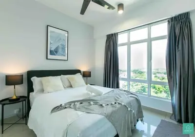 a bedroom with a bed and a large window at JOMSTAY Majestic Ipoh Suites in Ipoh