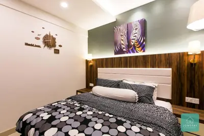 a bedroom with a black and white bed at JOMSTAY Majestic Premier Suites Ipoh Town in Ipoh