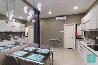 a kitchen with a table and chairs in a kitchen at JOMSTAY Majestic Premier Suites Ipoh Town in Ipoh