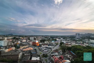 a view of a city with a cloudy sky at JOMSTAY Majestic Premier Suites Ipoh Town in Ipoh