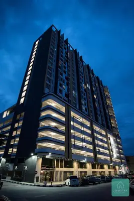 a large building with cars parked in front of it at JOMSTAY Majestic Premier Suites Ipoh Town in Ipoh