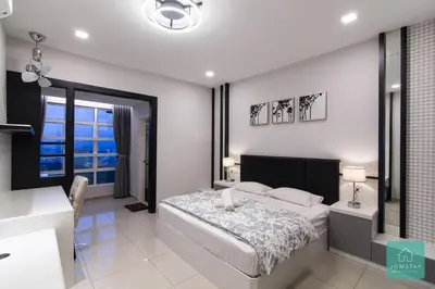 a white bedroom with a bed and a window at JOMSTAY Majestic Premier Suites Ipoh Town in Ipoh