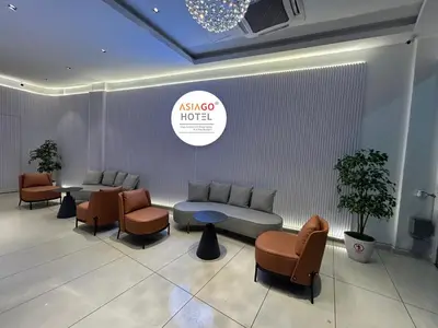 a waiting room with a couch and chairs and a table at Asiago Hotel in Sungai Petani