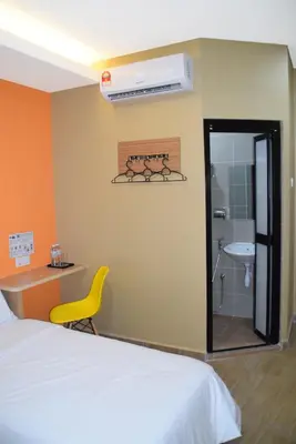 a bedroom with a bed and a bathroom with a sink at Asiago Hotel in Sungai Petani
