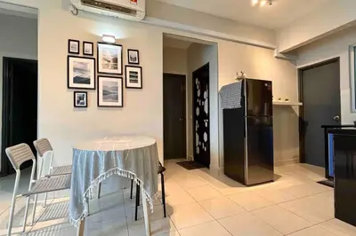 a dining room with a table and a refrigerator at Moderm Spacious 6pax S PICE Penang in Bayan Lepas