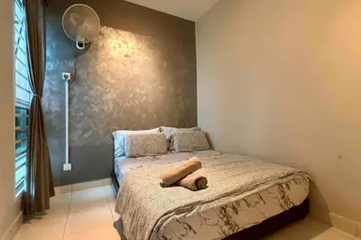 a bedroom with a bed with two towels on it at Moderm Spacious 6pax S PICE Penang in Bayan Lepas