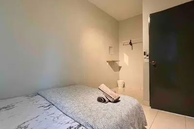 a bedroom with a bed with a pair of scissors on it at Moderm Spacious 6pax S PICE Penang in Bayan Lepas