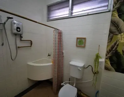 a bathroom with a toilet and a sink and a window at Sea Lion by the beach in George Town