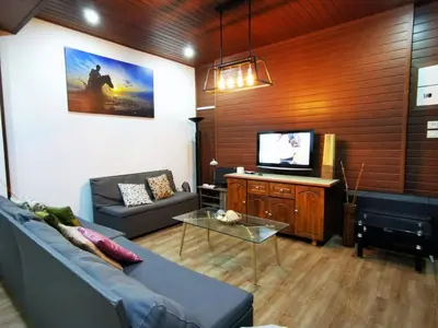 a living room with a couch and a tv at Sea Lion by the beach in George Town