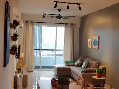 a living room with a couch and a large window at Nordiska @ Majestic Ipoh in Ipoh