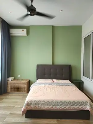 a bedroom with a bed with a ceiling fan at The Octagon Ipoh in Ipoh