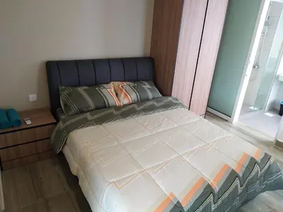 a bedroom with a large bed with a large window at The Octagon Ipoh in Ipoh