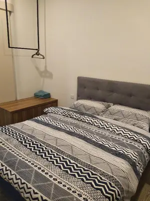 a bedroom with two beds and a lamp at The Octagon Ipoh in Ipoh