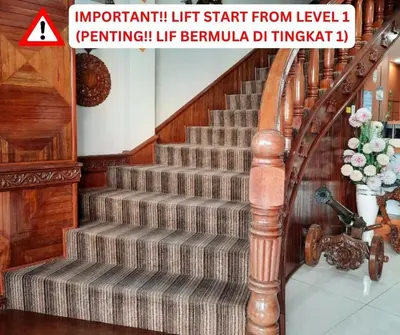 a staircase with a wooden railing and a stair case at Wan Alyasa Hotel in Cameron Highlands
