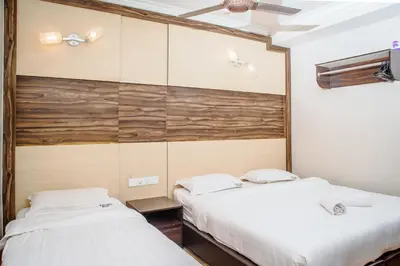 two beds in a room with wooden walls at Wan Alyasa Hotel in Cameron Highlands
