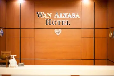 a wooden door with a hotel sign on it at Wan Alyasa Hotel in Cameron Highlands