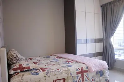 a bedroom with a bed with a quilt on it at H2H - Reunion House @ Majestic Ipoh \u5bb6\u597d\u6708\u5706 in Ipoh