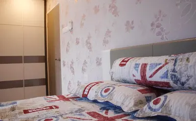 a bedroom with a bed with two pillows on it at H2H - Reunion House @ Majestic Ipoh \u5bb6\u597d\u6708\u5706 in Ipoh