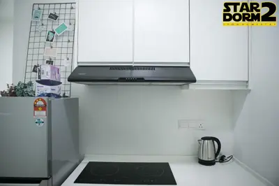 a kitchen with white cabinets and a stove top oven at Ipoh City Center Stardorm 2 Ipoh Homestay in Ipoh
