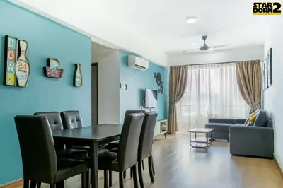 a dining room with a table and chairs and a couch at Ipoh City Center Stardorm 2 Ipoh Homestay in Ipoh