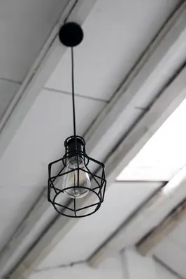 a black light fixture hanging from a ceiling at Stay SongSong Beach Street in George Town