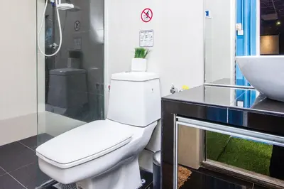 a bathroom with a toilet and a sink at SECRET STUDIO On Factory in George Town