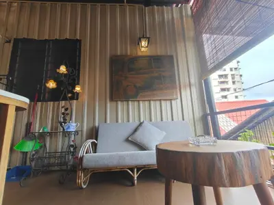 a living room with a chair and a table at SECRET STUDIO On Factory in George Town