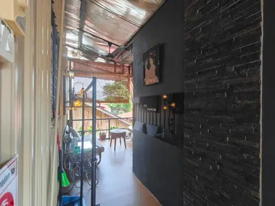 a room with a brick wall and a dining room at SECRET STUDIO On Factory in George Town