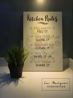 a sign that says kitchen rules on a table with a plant at Le Maison GuestHouse Ipoh @ Octagon in Ipoh