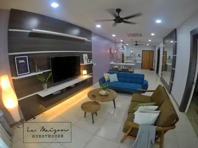 a living room with a blue couch and a tv at Le Maison GuestHouse Ipoh @ Octagon in Ipoh