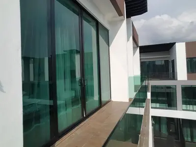 an empty balcony of a building with glass windows at Hermitage Boutique House in Taiping