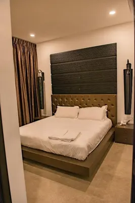 a bedroom with a large bed with a large window at Hermitage Boutique House in Taiping