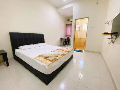 a bedroom with a large bed in a room at My STW Home 2 in Sitiawan
