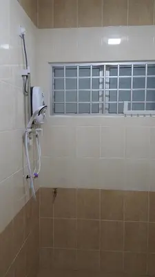 a shower in a bathroom with a window at My STW Home 1 in Sitiawan