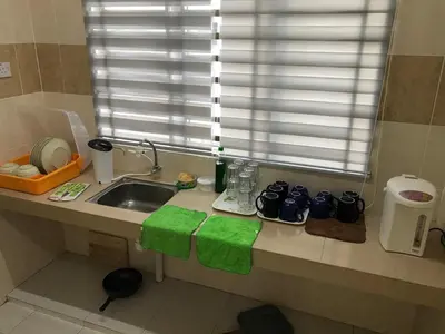 a kitchen counter with a sink and a window at My STW Home 1 in Sitiawan
