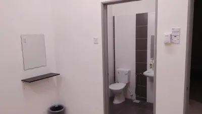 a bathroom with a toilet and a sink at MaiHomestay Seri Iskandar in Seri Iskandar