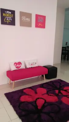 a couch in a room with a flower rug at MaiHomestay Seri Iskandar in Seri Iskandar