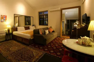 a hotel room with a bed and a couch at Muntri Mews in George Town