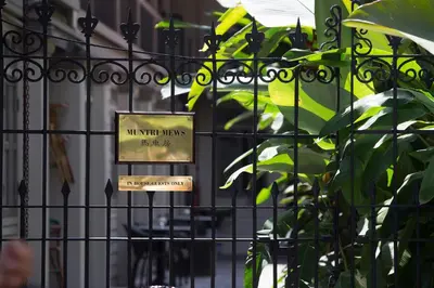 a sign on a gate in front of a building at Muntri Mews in George Town