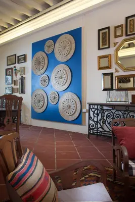 a living room with clocks on the wall at Muntri Mews in George Town